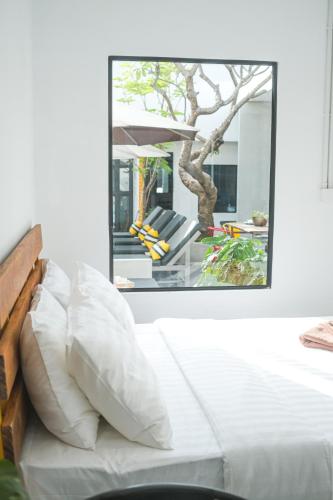 a living room with a white couch and a mirror at veHaa BOUTIQUE HOTEL in Phnom Penh