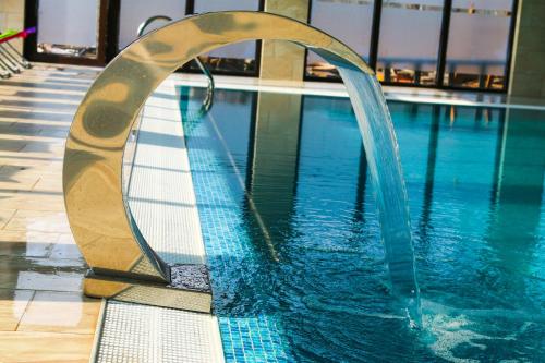 a swimming pool with a water slide in a building at Camves Inn in Sighetu Marmaţiei