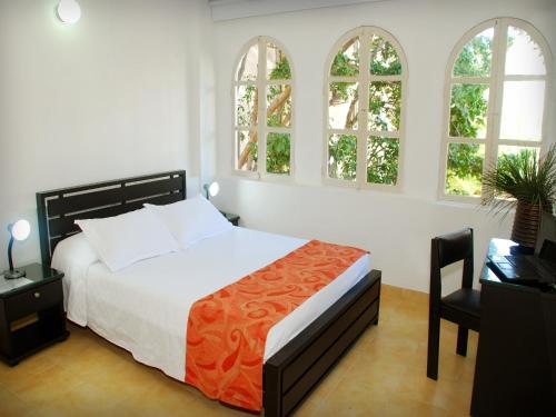 Ένα ή περισσότερα κρεβάτια σε δωμάτιο στο Hotel Edmar
