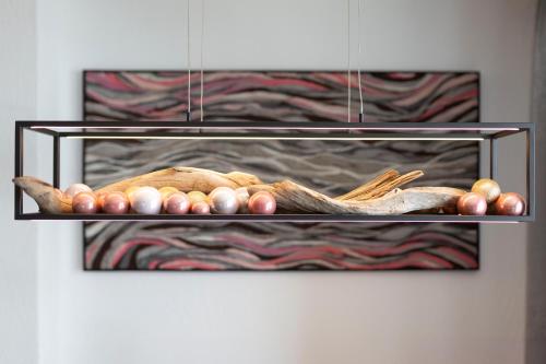 a hanging rack with chickens and vegetables in front of a fireplace at Apart-Pension Bergland in Ladis