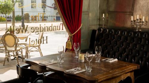 a table in a restaurant with wine glasses on it at The Tunbridge Wells Hotel in Royal Tunbridge Wells