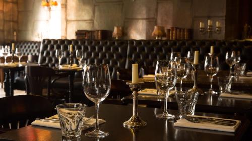 a group of wine glasses on a table in a restaurant at The Tunbridge Wells Hotel in Royal Tunbridge Wells