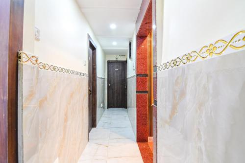 a hallway with a door and a tile floor at FabHotel MN International - Nr Park Circus in Kolkata