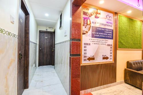 a corridor with a door and a poster on the wall at FabHotel MN International - Nr Park Circus in Kolkata