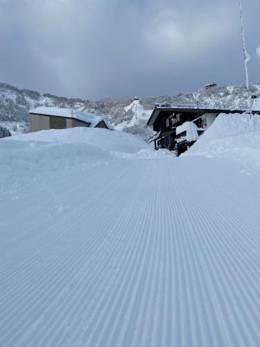 a pile of snow in front of a building at ロッヂノエル in Seki