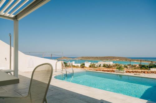 a swimming pool with a view of the ocean at Makrikythera Luxury Suites - Private Pool or Hot Tub Suites in Dhiakofti