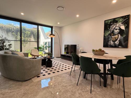 a living room with a table and a couch at Eastgardens 4Bed 3Bath Brand New Townhouse 2 Car in Sydney