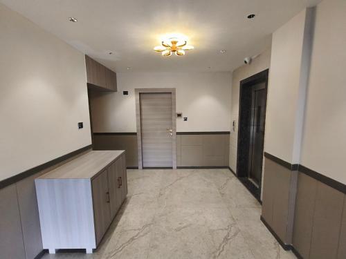 an empty room with a ceiling fan and a hallway at Nakshtra Residency Kalyan in Kalyan