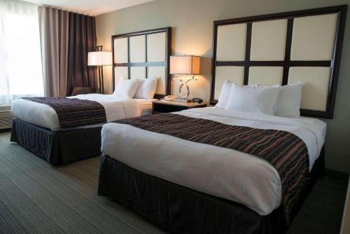 a hotel room with two beds and a window at Country Inn & Suites by Radisson, Effingham, IL in Effingham