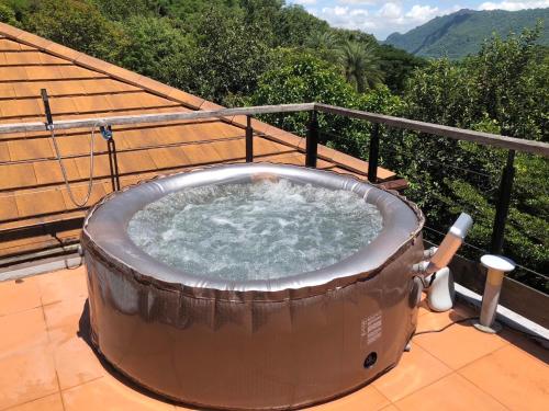 a hot tub on the balcony of a house at The Height Khaoyai Resort in Ban Huai Sok Noi