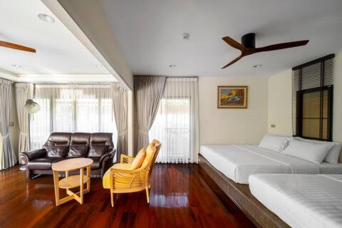a bedroom with a bed and a table and chairs at The Height Khaoyai Resort in Ban Huai Sok Noi