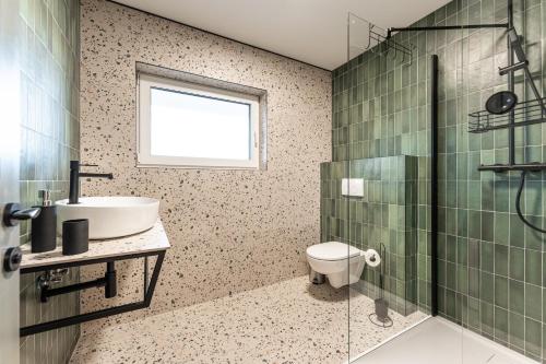 a bathroom with a sink and a toilet and a shower at Chaty Svätý Kríž in Svätý Kríž