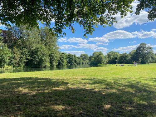 a park with a river and trees and a green field at The Windsor Room in Windsor