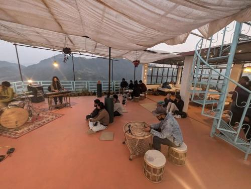a group of people sitting on the deck of a ship at Indralok Hotel and Sky Garden in Deorāli
