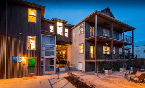 an apartment building with a patio and a green door at Rest, a boutique hotel in Plymouth