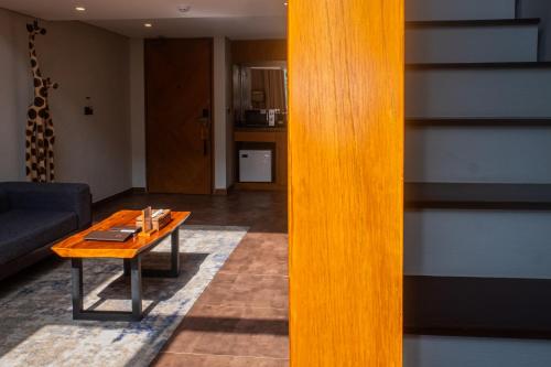 a living room with a table and a couch at Kayumas Seminyak Resort in Seminyak