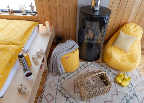 a room with a bed and two chairs and a fireplace at Wild House Donovaly in Donovaly