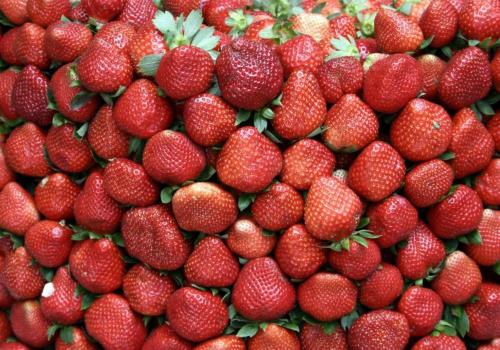 a pile of strawberries on display at a market at RedDoorz Hostel at MRC Residences Baguio in Baguio