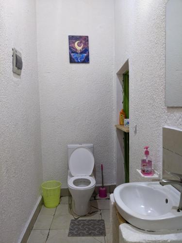a bathroom with a toilet and a sink at SAISH Stay in Ruhengeri