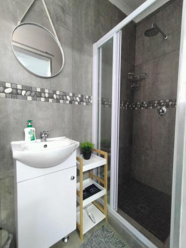 a bathroom with a sink and a shower at Anreith Close in West Point