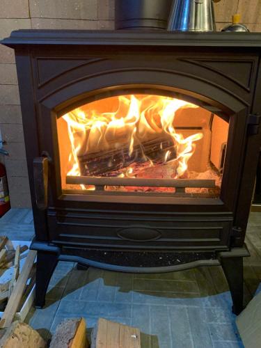 a stove with a fire inside of it at スヴァールバルレジデンス in Minamifurano