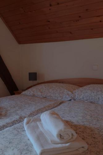 a bedroom with two beds with white towels on them at Mountain View Apartments - Pr` Potovcn`k in Dovje