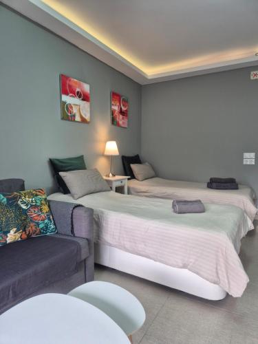 a living room with two beds and a couch at Studio in city in Fuengirola