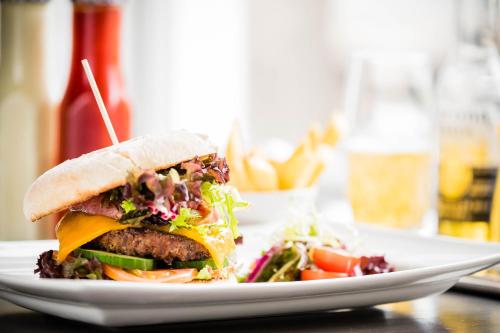 a sandwich on a white plate with a salad at Inverness Palace Hotel & Spa, WorldHotels Distinctive in Inverness