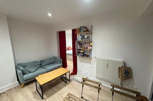 un salon avec un canapé et une table dans l'établissement T2 apartment near city center, à Gentilly