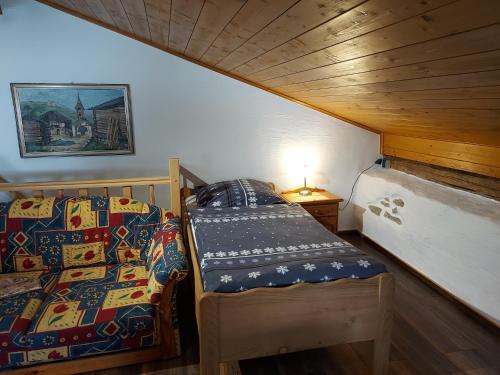 a bedroom with two beds in a room with wooden ceilings at Ferienhaus Rachelblick in Kirchberg