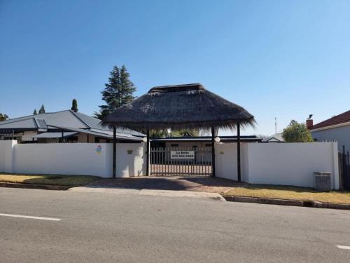 a house with a gazebo with a fence at La Belle Guesthouse Parys in Parys