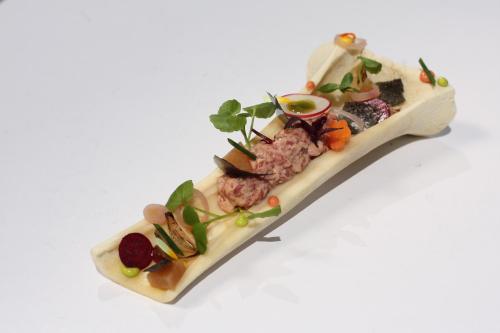 a plate of food on a white background at Hotel Vier Jahreszeiten Binz in Binz