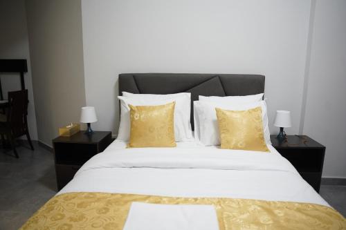 a bedroom with a large bed with yellow pillows at Ista Vacation Homes Rental LLC in Dubai