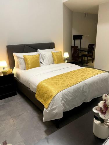 a bedroom with a large bed with yellow and white pillows at Ista Vacation Homes Rental LLC in Dubai