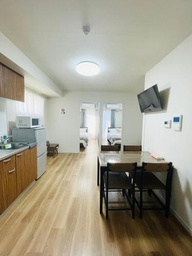 a kitchen and living room with a table and a dining room at T-Hotel 浅草 in Tokyo