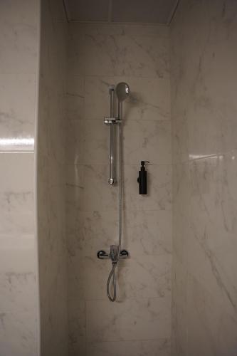 a shower with a shower head in a bathroom at Ista Vacation Homes Rental LLC in Dubai