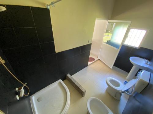 a bathroom with two toilets and a sink at NimSri Villa by Prazzventures in Mirissa