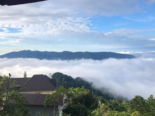 a view of a mountain with clouds in the sky at Rosa Homestay in Ấp Trạm Hành