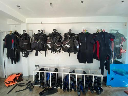 a room with a bunch of clothes hanging on a wall at NimSri Villa by Prazzventures in Mirissa