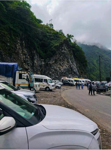 a bunch of buses parked in a parking lot at Sheetal Restaurant in Mussoorie