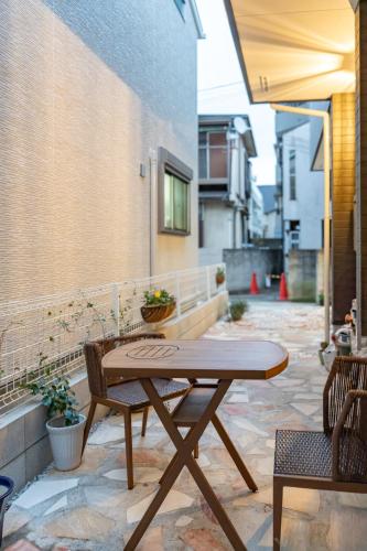 a wooden table and two chairs on a patio at 3 minutes walk to the station, direct to Ikebukuro, two-story house with a garden in Tokyo