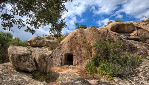 a cave in the rocks on a mountain at Sea Breeze Home in Lotzorai