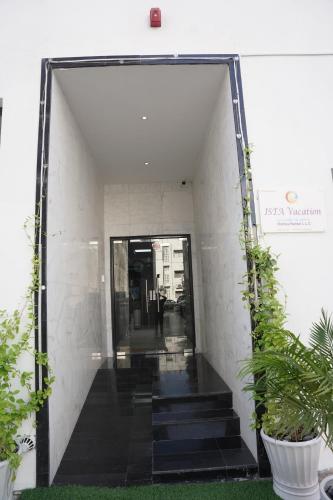 a hallway of a building with stairs and plants at Ista Vacation Homes Rental LLC in Dubai