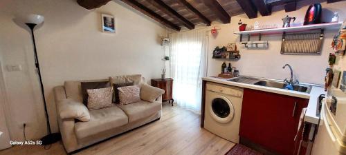 a living room with a couch and a washing machine at CA' POMPOSA bed & relax in Modena