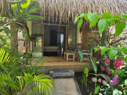 a patio of a house with a bunch of plants at MoonBag Bungalows in Gili Air