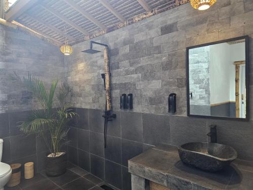 a bathroom with a sink and a mirror on the wall at MoonBag Bungalows in Gili Air