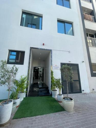 a white building with plants in front of it at Ista Vacation Homes Rental LLC in Dubai