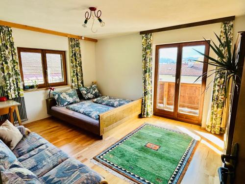a living room with a couch and a window at Haus Winkl 55 in Mariatal