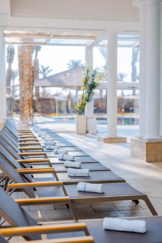 a row of lounge chairs lined up in a building at David Dead Sea Resort & Spa in Ein Bokek