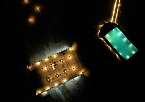 a green traffic light in front of a wall with lights at Thour Nature Resort - Jawai Leopard Safari Camp in Bera